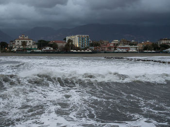 View of cityscape against storm clouds