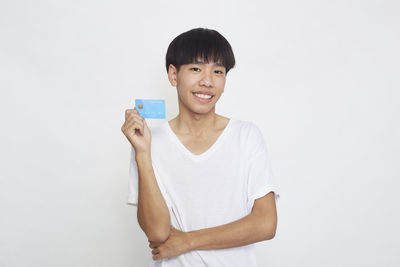 Portrait of smiling man standing against white background