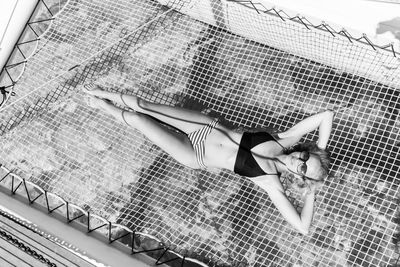 High angle view of woman relaxing in swimming pool