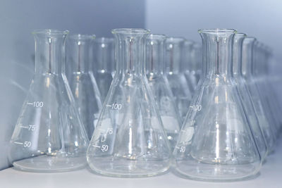 Close-up of conical flasks on table