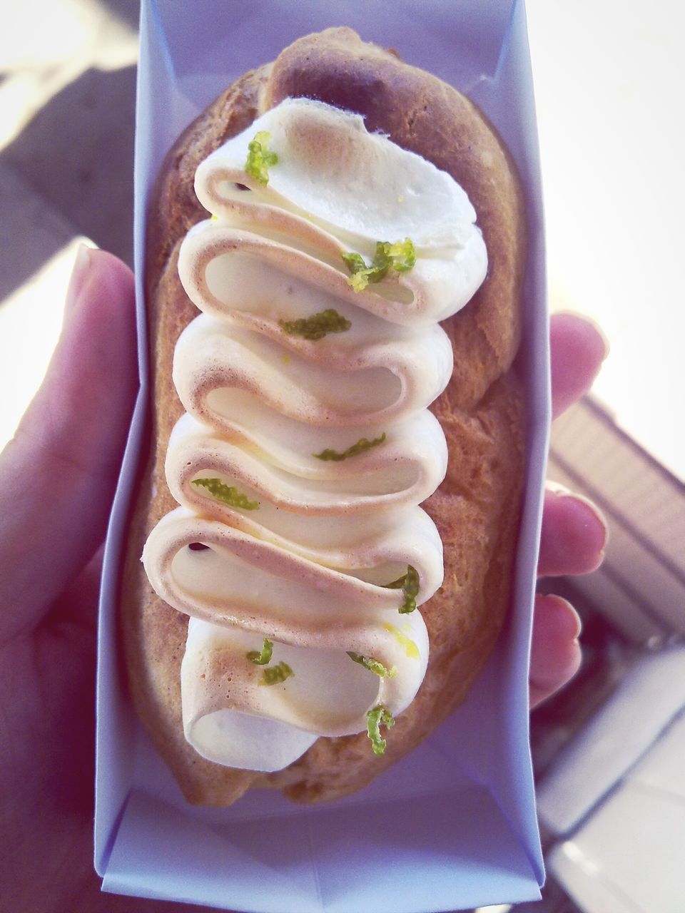 CLOSE-UP OF HAND HOLDING ICE CREAM IN PLATE