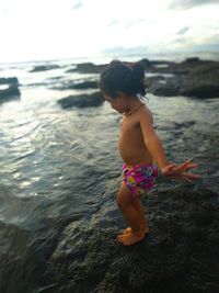 Rear view of woman standing in water