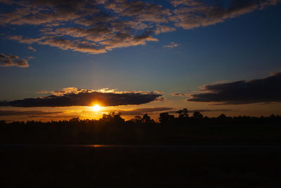 Scenic view of silhouette landscape against sky during sunset