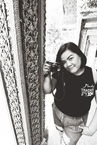 Portrait of young woman using mobile phone