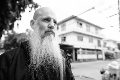 Portrait of man looking away in city