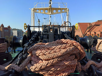 Fishing net at harbor against clear sky