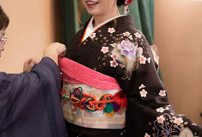 Midsection of woman standing at home