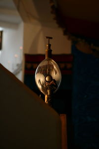 Close-up of illuminated electric lamp at home