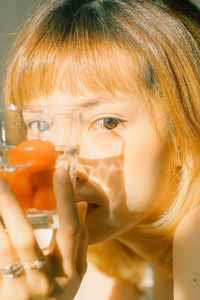 Close-up portrait of a woman drinking glass