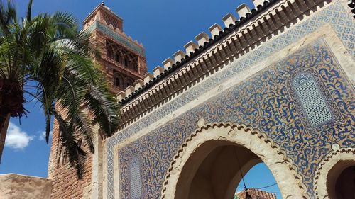 Low angle view of minaret and tree