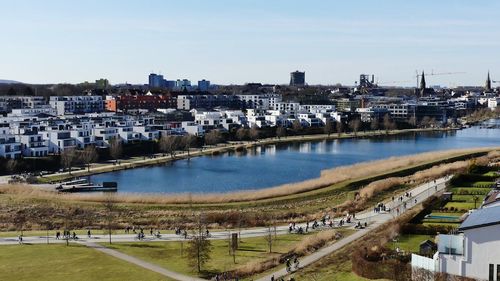 High angle view of river by buildings against sky