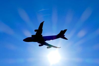 Low angle view of airplane flying in sky