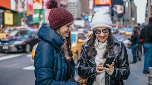 Women standing on city street during winter