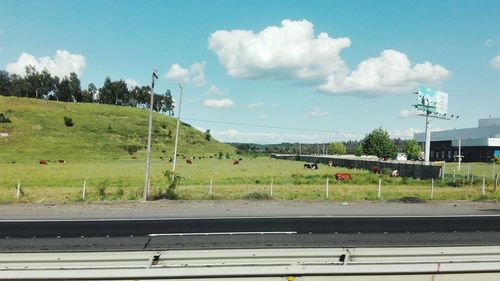 Road by landscape against sky