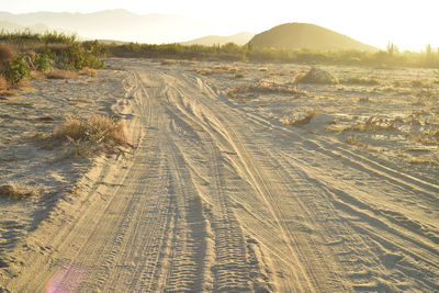 High angle view of dirt road on land