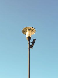 Low angle view of street light against clear blue sky