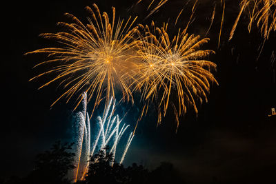 Low angle view of firework display at night