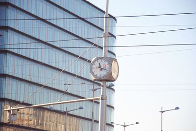 Low angle view of clock against clear sky