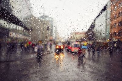 Raindrops on glass window in rainy season