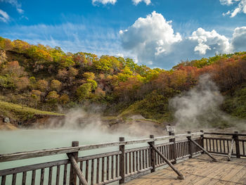 Scenic view of waterfall against sky