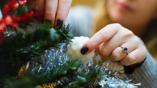 Midsection of woman holding christmas tree