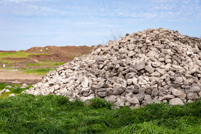 Scenic view of rocks on field against sky