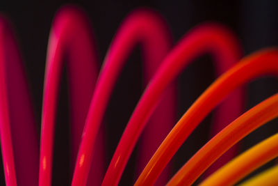 Full frame shot of coiled spring against black background