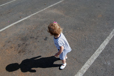 High angle view of girl standing on road