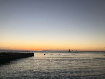 Scenic view of sea against clear sky during sunset