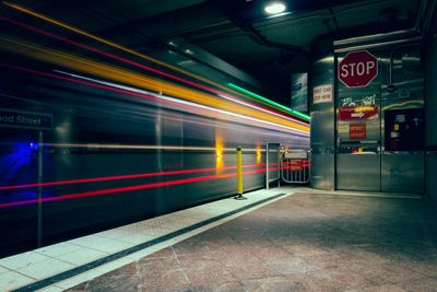 Blurred motion of train at railroad station platform during night
