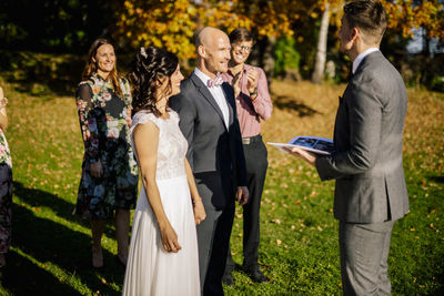 Happy couple looking at wedding planner