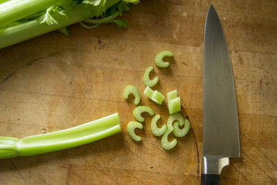 High angle view of celery and knife on cutting board
