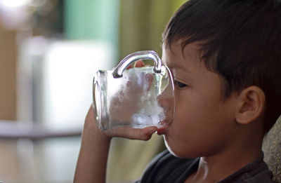 Close-up portrait of boy drinking glass