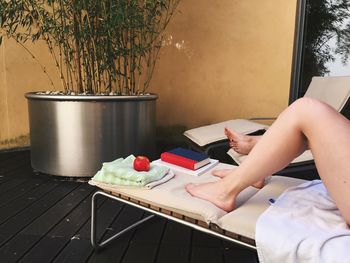 View of women's legs lying on lounger