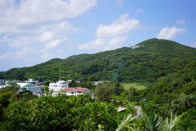 Scenic view of trees and mountains against sky