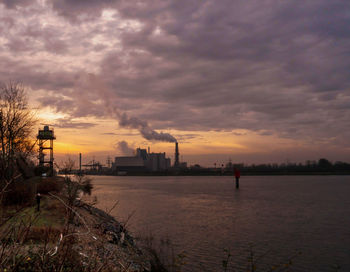 Silhouette of factory at sunset