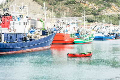 Boats moored at harbor