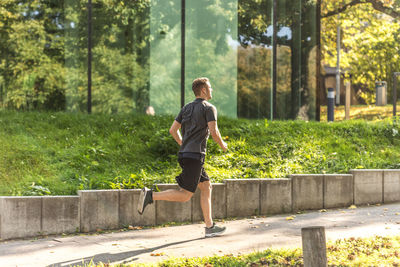 Full length side view of young man on plants