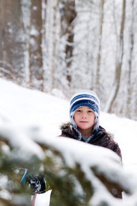 Portrait of a smiling boy in snow