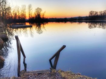 Scenic view of lake against sky during sunset