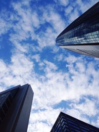 Low angle view of buildings against cloudy sky