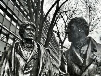 Low angle view of statue against sky in city