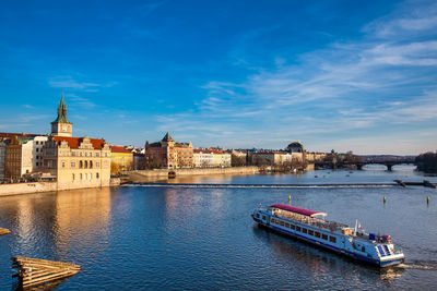 Boats in river with buildings in background