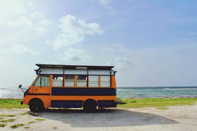 Bus parked by sea