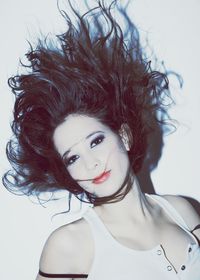 Portrait of young woman against white background