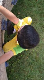 High angle view of siblings lying down on land