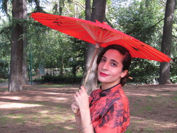 Portrait of a smiling young woman in rain