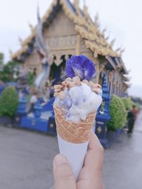 Cropped hand holding ice cream cone