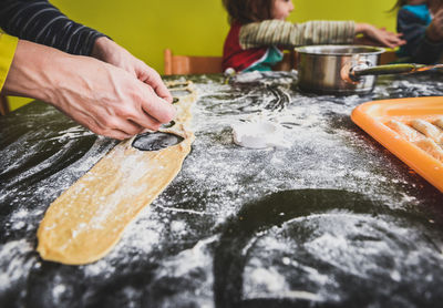 Cropped image of woman preparing ravioli on table