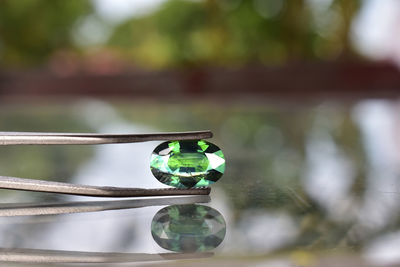 Close-up of water drop on metal container in lake